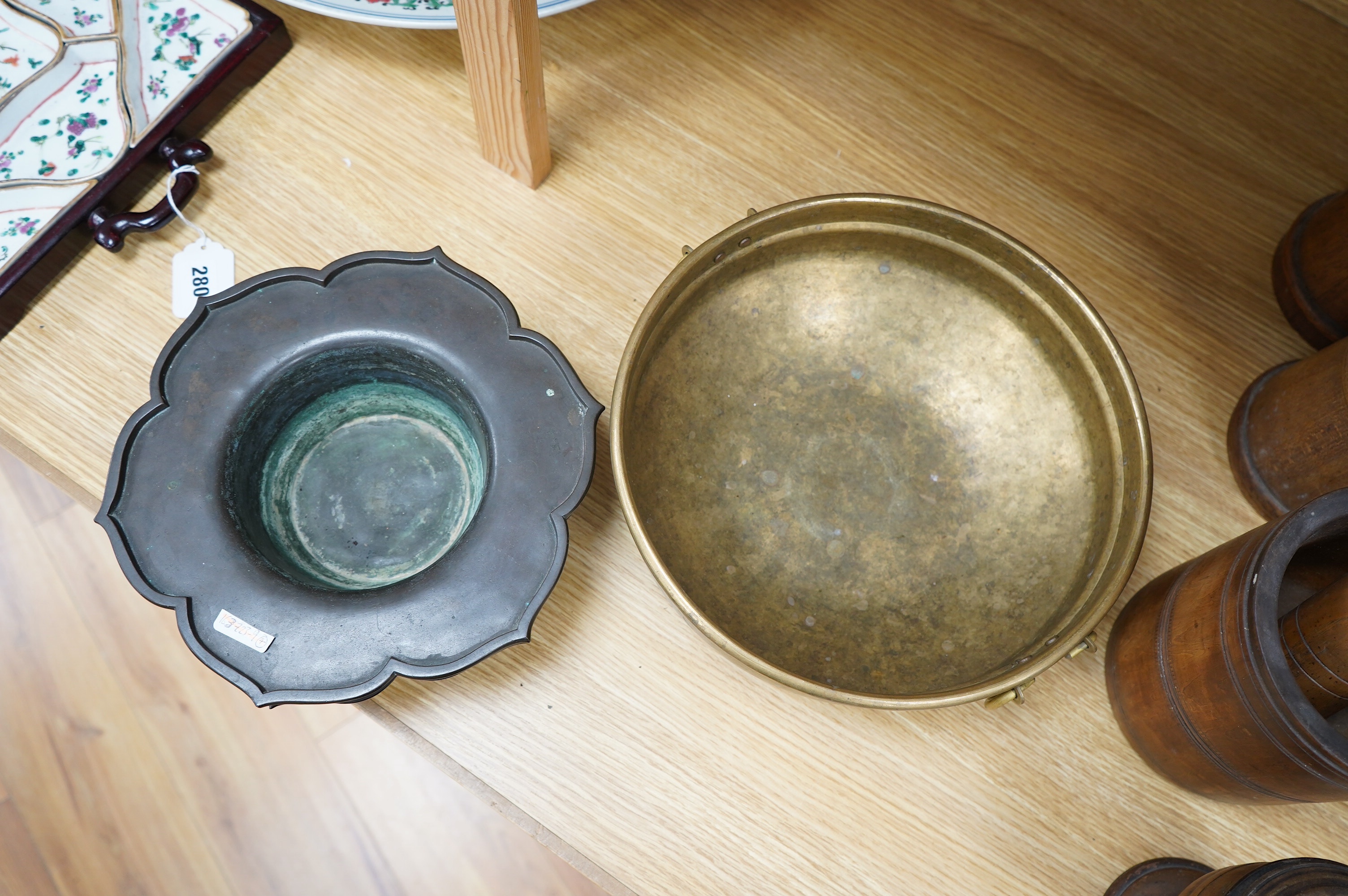 A Chinese bronze lotus dish with reticulated border, 27cm diameter, and a bronze two handled bowl, 29cm diameter. Condition - fair